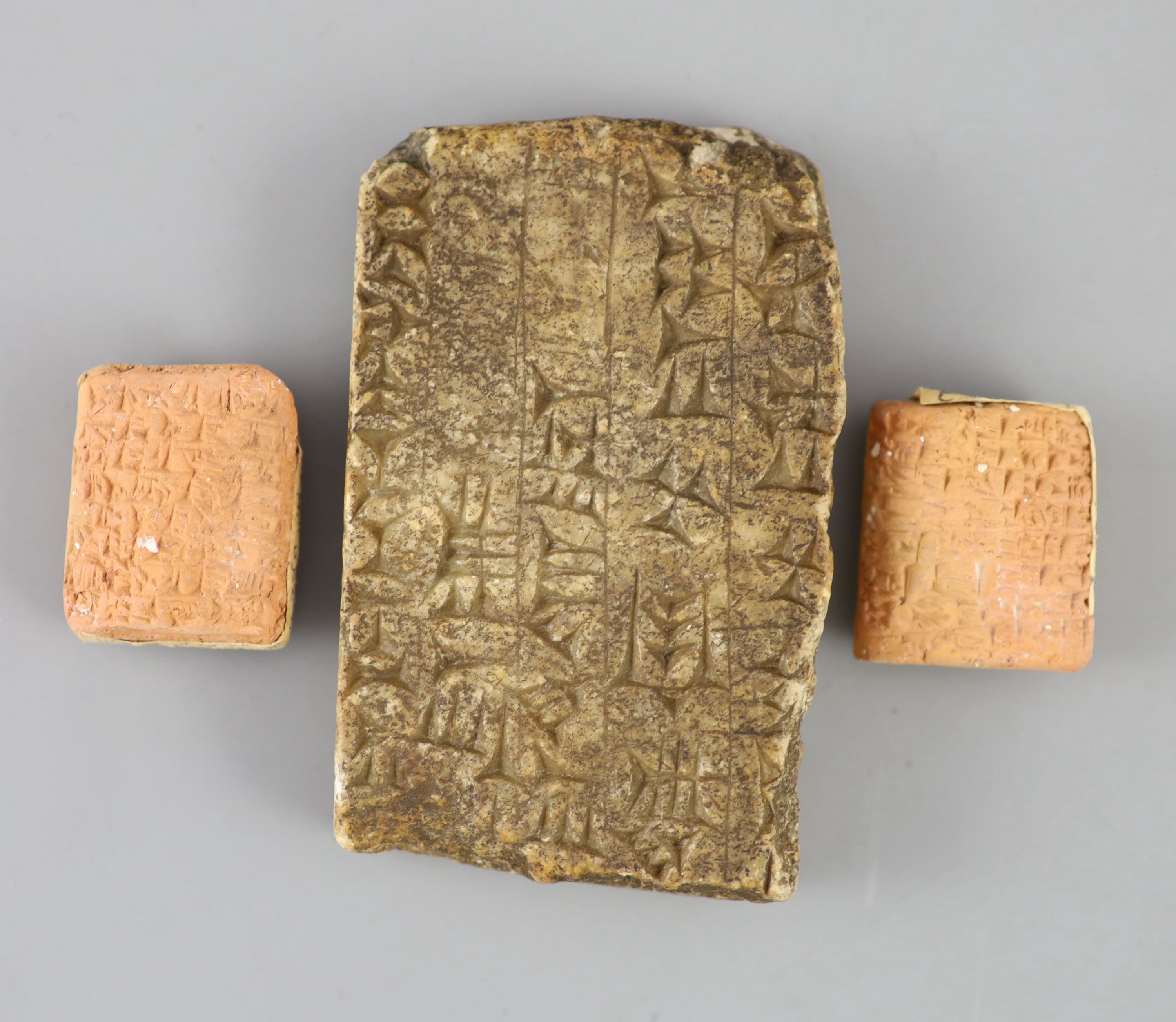 An Ancient Assyrian fragment of a cuneiform alabaster slab, probably 9th century BC from Kouyunjik (Nineveh) and two clay cuneiform tab